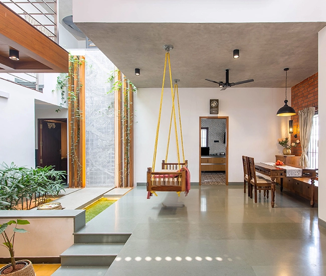 Central glass-roofed courtyard design at Dr. V Residence